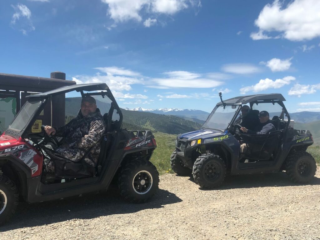 group of riders enjoying the southwest montana trails in red and blue polaris razr side by side UTVs